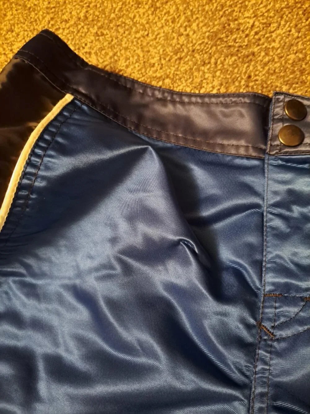 Vintage Fox Racing board shorts featuring a blue satin finish &white piping.